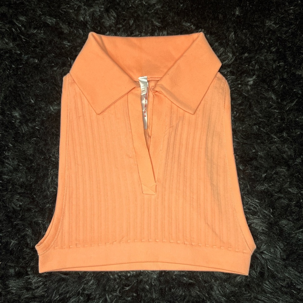 Collared vest top in a peach almost salmon color. Size medium.